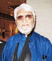 Profile photograph of an old man in white beard and hair.