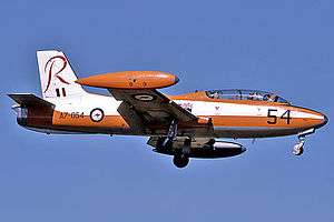 Side view of two-seat, single-engined military jet in flight, wheels down