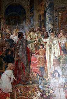 A bearded man wearing a crown takes the hand of a women in white cloths